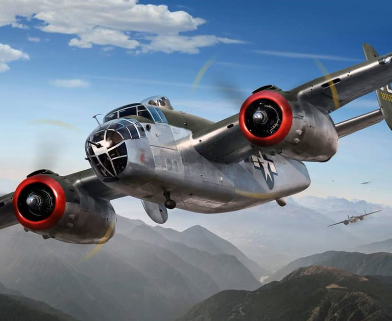 WWII B-25 bomber flying over mountains