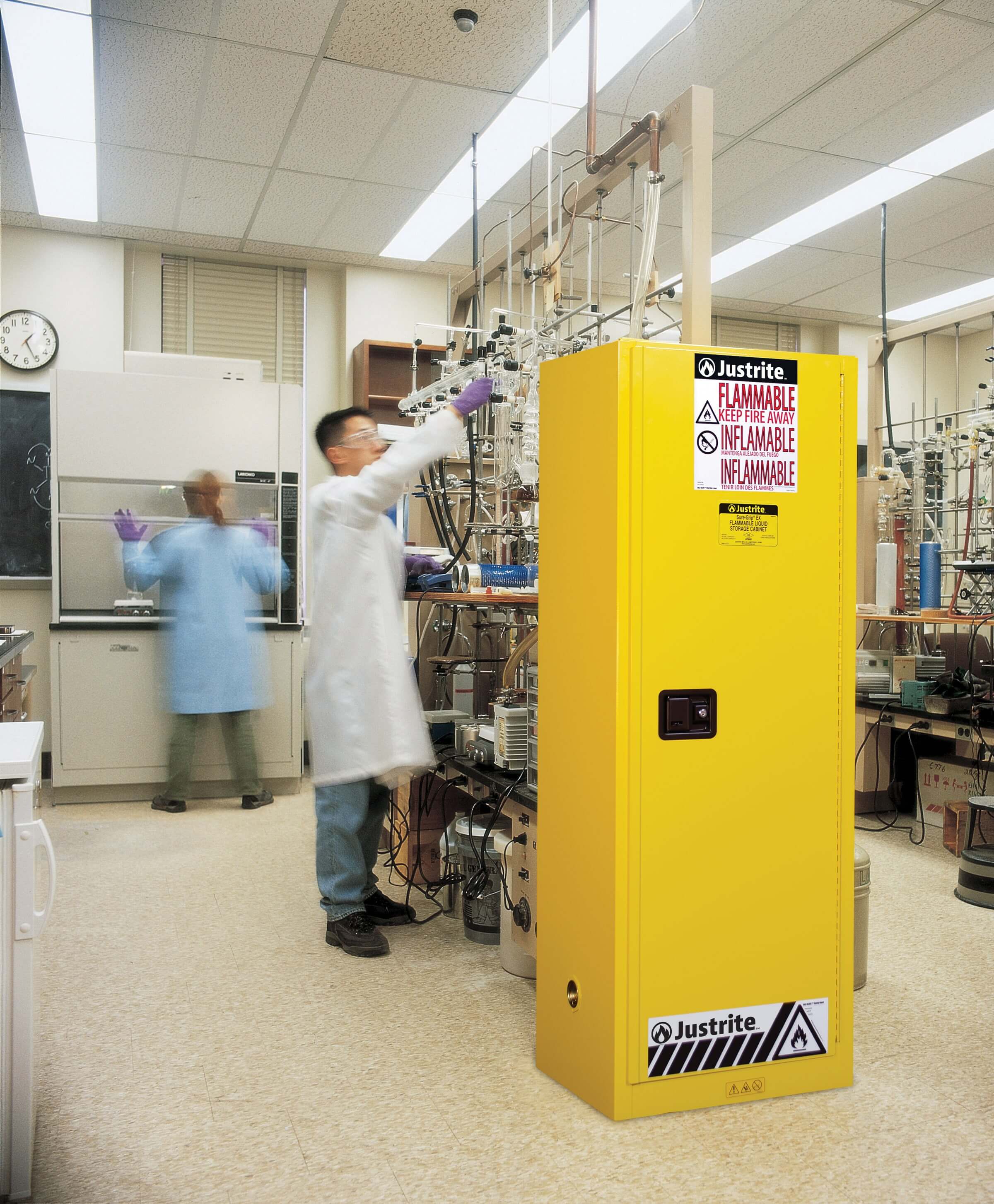 Yellow flammable cabinet in lab used to store flammable hazardous containers