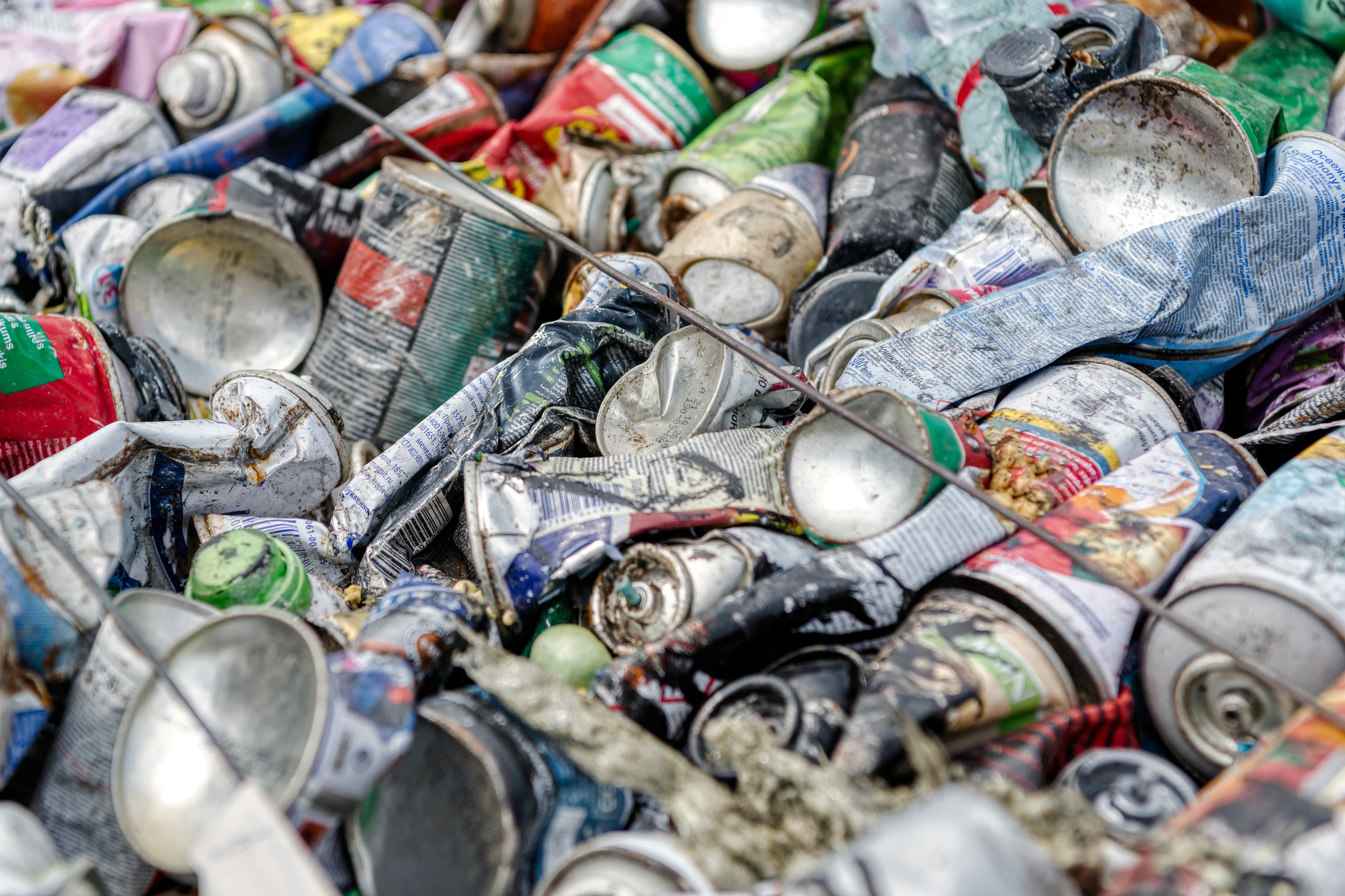 Old aerosol cans in trash