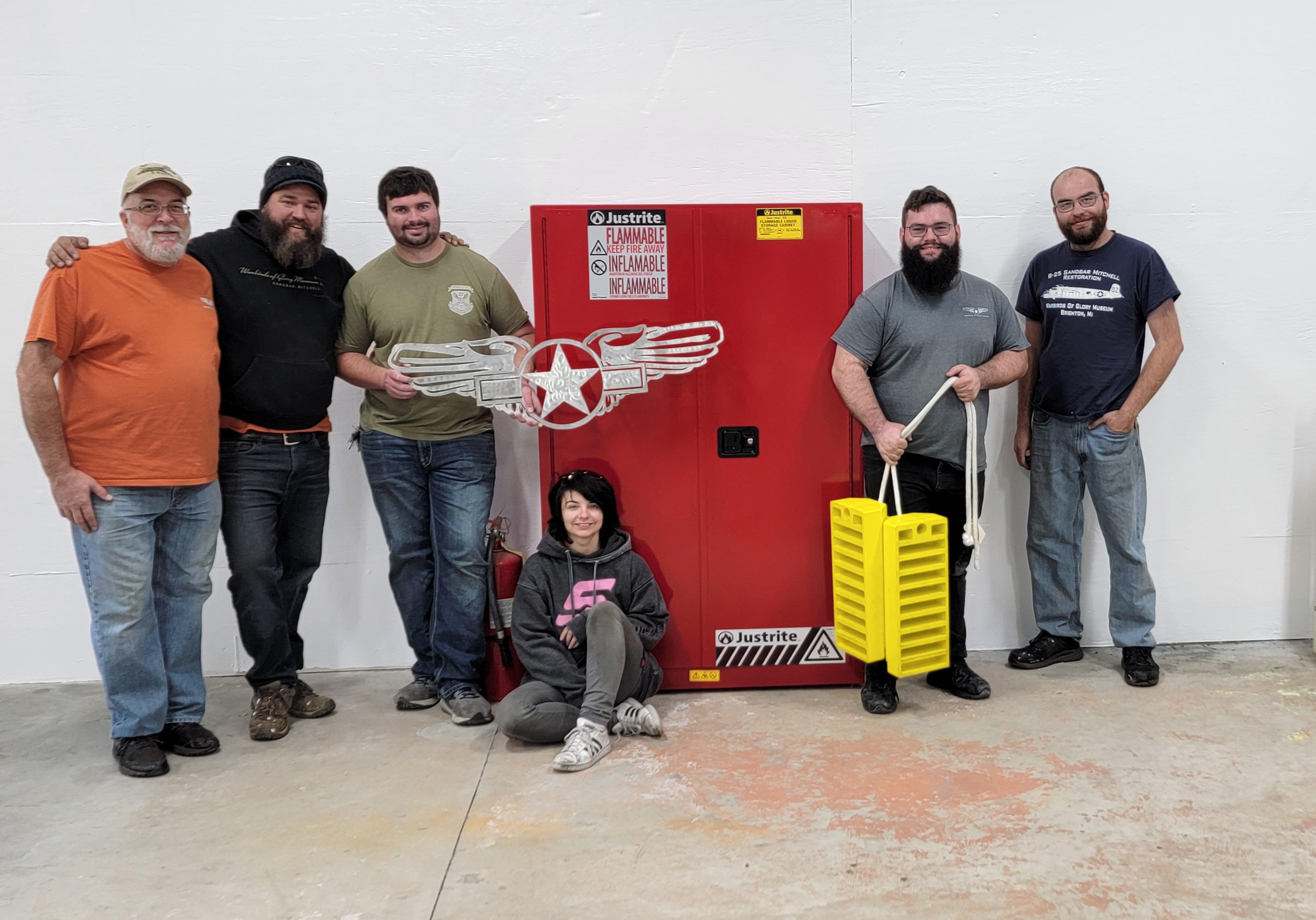 Students and teachers in workshop of Warbirds of Glory B-25 aircraft restoration program